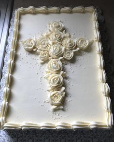 a cake with white frosting and roses on it