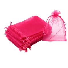 a stack of pink napkins sitting next to each other on top of a white surface