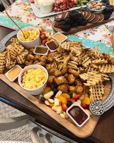 a platter filled with waffles, fruit and other snacks