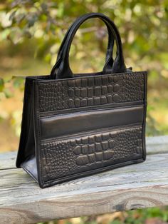 "Women's handcrafted Small Tote and Cross-body bag, perfect for everyday life or travel in style, made of cow-hide leather simulating crocodile pattern, very classic design, fits all your basics and more. Beautiful leather simulating crocodile pattern Inside features one zip pocket, one-slide pocket in one side, and two-slide pockets in the other Adjustable Removable Leather Strap 40\" long Measurements 11\" L x 18.5\"H x 4.5' D Zip Closure Cow-hide Leather Imported from Mexico Handcrafted Perfe Rectangular Faux Leather Box Bag For Everyday, Square Faux Leather Box Bag, Rectangular Faux Leather Bag With Top Carry Handle, Rectangular Faux Leather Box Bag With Top Carry Handle, Rectangular Faux Leather Box Bag With Top Handle, Everyday Use Top Handle Shoulder Bag With Crocodile Pattern, Top Handle Shoulder Bag With Crocodile Pattern, Everyday Crocodile Pattern Shoulder Bag With Top Handle, Rectangular Faux Leather Satchel With Top Handle