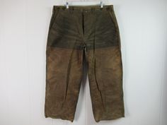 "Vintage 1980s(?) khaki cotton tin cloth waxed/oiled hunting pants. Made by Filson. Has donut hole suspender buttons and a button fly. Two front pockets, small pocket and two rear pockets. Size 40. Actual measurements are: 40\" around the waist 27.5\" inseam 39\" overall length Good patina and condition. Has ben cut off at hems. Small repair on leg." Vintage Cotton Outdoor Pants, Khaki Vintage Pants, Brown Vintage Pants For Winter, Vintage Brown Winter Pants, Vintage Brown Work Pants With Belt Loops, Vintage Cotton Bottoms For Outdoor, Vintage Coveralls, Vintage Clothing, Denim Coverall