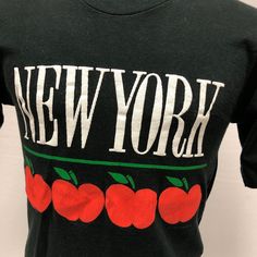 "90's Men New York The BIG APPLE Spellout Graphic Black 1990s T-Shirt S Retro N Measurements Chest: 36 Length:26 Seller Notes: \"Article is in excellent vintage condition.\" Brand: Fruit of the Loom Material: 100% Cotton Decade: 1990s Style: Graphic Tee Color: Black, red Country/Region of Manufacture: United States Gender: Men Original/Reproduction: Original Look: retro Size Type: Regular Personalized: No Chest Size: 36 Modified Item: No Sleeve Length: Short Sleeve" Retro Black T-shirt For Fall, Vintage Black T-shirt For Fall, Retro Graphic Design Tops For Fall, Black Retro T-shirt For Fall, Vintage Graphic Tops For Fall, Vintage Text Print T-shirt For Fall, Vintage Graphic Design T-shirt For Fall, Vintage Graphic T-shirt For Fall, 90s Text Print T-shirt For Fall