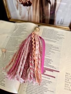 an open book with some tassels on it