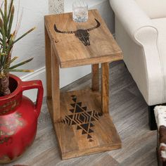 a small wooden table with a cow skull on it