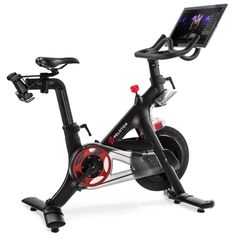 an exercise bike with a tablet on the handlebars and monitor mounted to it