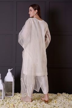 White organza kurta with zari and thread embroidery. Comes with modal satin dhoti pant and a dupatta. - Aza Fashions Traditional Drape Kurta In Organza With Cutdana, Traditional Drape Organza Kurta With Cutdana, Navratri Organza Kurta With Gota Work, Eid Organza Kurta With Gota Work, Organza Kurta With Gota Work In Traditional Drape, Organza Straight Kurta With Gota Work, Traditional Organza Kurta With Gota Work, Designer Organza Kurta For Navratri, Organza Churidar With Chikankari Embroidery