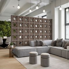 a living room filled with lots of furniture next to a wall covered in mirrors and lights