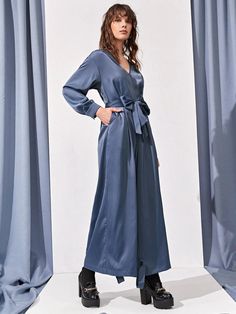 Step out in style with our Hidden Pocket Knot Hem Belted Jumpsuit. This elegant jumpsuit features a high waistline, wide leg, and drop shoulder sleeves for a comfortable fit. The V-neckline and belted waist add a touch of sophistication, while the hidden pockets offer a convenient place to store your essentials. The knot hem and zipper details complete the look, making it perfect for any occasion. Made from non-stretch fabric with a blend of polyester and elastane, it is both durable and comfortable. Machine wash or dry clean for easy care. Make a statement with this plain pattern jumpsuit, exclusively available at Comfy Jumpsuits. Specifications: Style: Elegant Pattern Type: Plain Type: Wide Leg Details: Belted, Knot, Pocket, Zipper Length: Long Fit Type: Regular Fit Neckline: V neck Slee Pattern Jumpsuit, Elegant Jumpsuit, Comfy Jumpsuits, Belted Jumpsuit, Belt Jumpsuit, Jumpsuit Elegant, Jumpsuit Pattern, Hidden Pocket, Zipper Detail