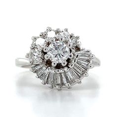 Vintage 14k White Gold Round Cut Center With A Halo Of Round & Baguette Diamond Ring  Size 6.75 5.7 Grams  Round & Baguette Cut Diamonds 1 Carats Total Weight Clarity: Vs-Si Color: G-H This is a gorgeous vintage 14k white gold diamond ring showing off these bright diamonds. if you have any questions or concerns please let me know and I will get back to you as soon as possible. Serial number: AJ 057423 A Platinum Cluster Ring With Baguette Diamond Cut, Platinum Cluster Ring With Baguette Diamonds For Anniversary, Fine Jewelry Cluster Ring With Baguette Diamonds, Platinum Cluster Diamond Ring With Baguette Diamonds, Platinum Diamond Ring With Baguette Diamonds For Anniversary, Platinum Cluster Ring With Baguette Diamonds For Wedding, Classic Cluster Diamond Ring With Baguette Diamonds, Art Deco White Gold Rings With Baguette Diamonds, White Gold Cluster Ring With Baguette Diamonds