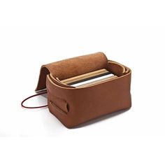 a brown leather case with a cell phone in it