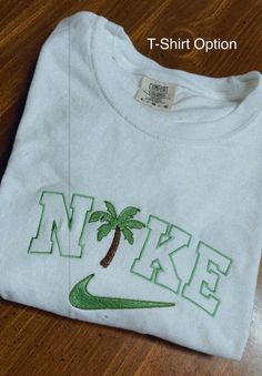 Palm Tree Crewneck/T-Shirt – Rags Revived Nike Palm Tree Sweatshirt, White Cotton Crew T-shirt, White Embroidered T-shirt For College, Trendy White Pre-shrunk Sweatshirt, White Pre-shrunk Sweatshirt For Streetwear, White Sweatshirt For Streetwear, White Embroidered Graphics T-shirt For College, Unisex White Sweatshirt With Letter Print, Unisex White Letter Print Sweatshirt