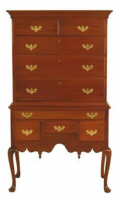 an old wooden dresser with gold leaf decorations on it's drawers and two legs