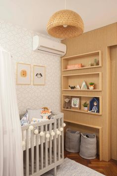 a baby's room with a crib, bookshelf and other items