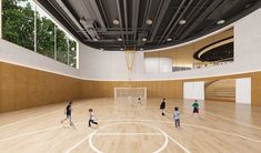 an indoor basketball court with children playing on it