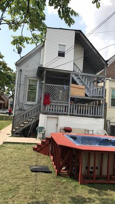 an above ground hot tub in front of two houses