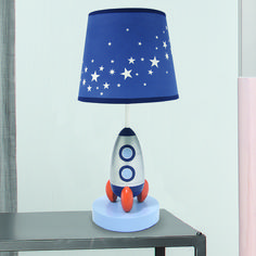 a lamp that is sitting on top of a table with a rocket ship underneath it