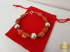 "◎ Sterling silver bracelet made from semi-rustic shaped beads of precious, orange Mediterranean coral. The coral is unique, all natural and hasn't been treated or dyed in any way. Adorned with decorative ball elements, and various spacer beads. Everything is handmade in sterling 925 silver. ◎ Locking length: 18 cm ( 7.1\" ) Silver ball element diameter: 10.5 and 12 mm ( 0.41 and 0.47\" ) ◎ Enter the shop, for more of our jewelry, and matching necklace ;) ◎ - - - - - - - - - - - - - - - - - - - Coral Bracelet, Ball Bracelet, Orange Coral, Natural Coral, Coral Jewelry, Bracelet Sterling Silver, Bracelet Silver, Matching Necklaces, Sterling Silver Bracelet