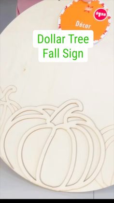 a wooden cutting board with pumpkins on it and the words dollar tree fall sign