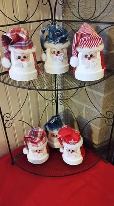 there are many santa claus hats on this shelf in front of the fire hydrant