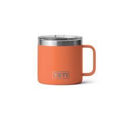 an orange yeti mug with the word yeti on it and a silver lid