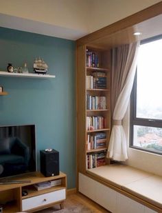 a living room filled with furniture and a flat screen tv sitting on top of a wooden shelf