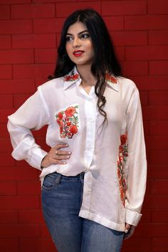 A stunningly marvellous Top. This Shirt Top features Multi-Colour Kashmiri Aari embroidery on Collar and shirt Pocket.- - - - - - - - - - - - - - - - - - - - Product Details- Condition: Brand New (made to order)- Brand: Glancia by Angad Creations- Style: Shirt Top- Fabric: Monga Cotton- Base Colour: White- Embroidery: Kashmiri Thread Embroidery- Embroidery Colour: Multi-Color- Standard Length: 27" (69 cm) approx. | Can be Customized - Care Instructions: Dry Clean Only**If you want the top to be Traditional Embroidered Fitted Shirt, Traditional Fitted Embroidered Shirt, Festive Traditional Shirt With Resham Embroidery, Festive Embroidered Fitted Shirt, Festive Fitted Embroidered Shirt, Festive White Top With Embroidered Sleeves, Festive Casual Floral Embroidered Top, Festive Long Sleeve Shirt For Spring, Traditional Long Sleeve Shirt With Intricate Embroidery