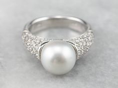 This pearl and diamond ring is the best of modern luxury! The pearl is a shimmering dove grey, with a sophisticated hue that plays off the crisp polish of the 18 karat white gold. Diamond encrusted shoulders heighten the glamour of this eye-catching ring! Metal: 18K White Gold Gem: Grey Pearl Gem Measurements: 9.9 mm, Round Accents: 82 Diamonds totaling 1.50 Carats, VS2 in Clarity, G in Color Ring Size: 7.50 Marks: "750" Stamped on the inside band Pearl Ring Design, Bridal Jewelry Pearl, Yellow Gold Sapphire Ring, Vintage Drop Earrings, Romantic Rings, Pearl And Diamond Ring, Gold Statement Ring, Jewelry Pearl, Diamond Anniversary