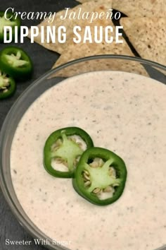 dip in a bowl with green peppers and tortilla chips on the side for dipping