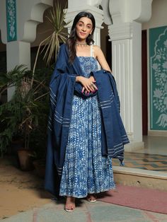 Farah smoked printed blue anarkali suit with pant and dupatta set is perfect for a festive season . Cotton cambric fabric makes it perfect for summer weather. Mirror work shell strap with gota detailing on the dupatta give the set a classic look. Product has lining. Pant has two side pockets, back elasted waistband. Cold wash and Dry clean only.Type of Work: Hand Block/ Solid Fit: Fitted at bust Model Height: 5'4 Measurements: Kurta- 52.25" Pants- 36.25" Dupatta- 95.75" SKU#: 11703066BL Disclaim Indigo Salwar Kameez With Dupatta For Navratri, Navratri Indigo Salwar Kameez With Dupatta, Festive Indigo Anarkali Set With Dupatta, Indigo Anarkali Set For Festive Diwali Occasion, Bohemian Blue Palazzo Set For Festivals, Blue Bohemian Palazzo Set For Festivals, Indigo Anarkali Dupatta For Eid, Blue Bohemian Chanderi Palazzo Set, Blue Bandhani Print Palazzo Set For Festive Occasions