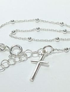 Rosary bracelet with cross in 925 sterling silver. -Classic Model -Casual design -Ideal for a gift -With gift envelope -symbol of being in grace with God when the bracelet comes with ten beads symbolizing to pray the rosary. Also the Christian cross. - Measures 17 cm long plus 3 cm extension. Silver Minimalist Rosary Bracelet As Gift, Adjustable Cross Rosary Bracelet As Gift, Adjustable Chain Cross Rosary Bracelet As Gift, Adjustable Cross Chain Bracelet As Gift, Silver Cross Chain Bracelet As Gift, Rosary Bracelet With Cross And Adjustable Chain For Gifts, Silver Crucifix Jewelry With Silver Chain, Nickel Free Silver Cross Bracelets, Nickel Free Cross Bracelet With Spiritual Style