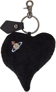 a black heart shaped keychain with a space shuttle embroidered on the front and back