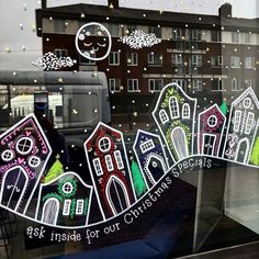 the window is decorated with houses and stars