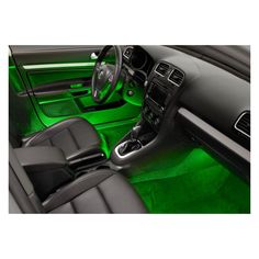 the interior of a car with green lights