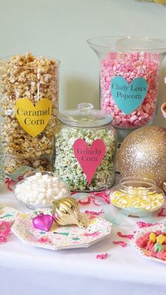 the table is set up with candy, popcorn and candies for valentine's day