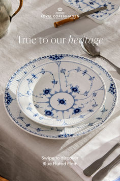 an image of a table setting with blue flowers on the plate and silverware in the bowl