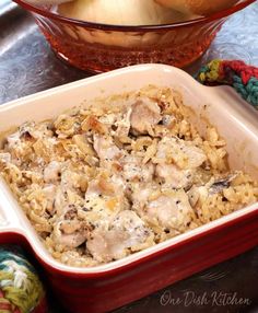 a casserole dish with chicken and rice in it next to an apple on the side