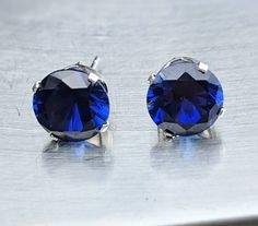 "Fast Free Shipping. Certified and tested on the most accurate gemstone testing machines. Stones came from ethical and reliable sources. You can either choose from sterling silver crown settings as in the photo or 14k solid gold basket settings. Sterling silver ships 1-3 business days. solid gold takes 2-5 Business days You will love these dark blue sapphire earrings. These high-quality Sapphire earrings will bring you focus and joy. Set in friction 4 prong setting to allow light behind the gem Sapphire Birthstone Earrings For Formal Occasions, Classic Sapphire Birthstone Earrings, Classic Blue Diamond-cut Earrings, Classic Blue Diamond Cut Earrings, Formal Sapphire Earrings With Birthstone, Formal Sapphire Birthstone Earrings, Classic Blue Round Earrings, Diamond Cut Sapphire Earrings For Gift, Blue Diamond Cut Round Earrings