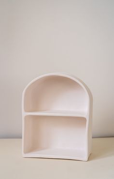 a white shelf sitting on top of a table