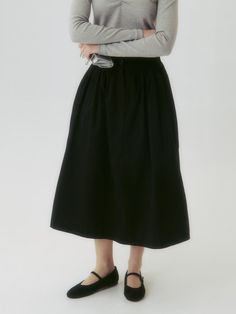 This product is a Button Flared Skirt, designed with a graceful flared silhouette that adds a touch of elegance and movement to the overall look. Its high-waist style accentuates the waistline, while the button details provide a classic and refined touch. This versatile skirt is suitable for both formal and casual settings, offering endless styling possibilities. - The skirt features a flared design that creates a sophisticated and feminine silhouette.- A series of buttons along the front add a vintage charm and visual interest.- Made from a smooth fabric, the skirt ensures comfort and a fluid drape.- Its versatile style pairs well with both fitted tops for a polished look and casual tees for a more relaxed outfit. Flared Workwear Skirt With Button Closure, Flared Work Skirt With Button Closure, Workwear Flared Skirt With Button Closure, Elegant Black Cotton Skirt, Classic Black Maxi Skirt For Spring, Black Voluminous Skirt For Daywear, Elegant A-line Skirt With Button Closure, Elegant Buttoned Flared Maxi Skirt, Chic Flared Skirt Bottoms With Button Closure