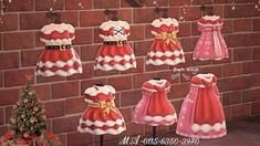 a display of christmas dresses on mannequins in front of a brick wall