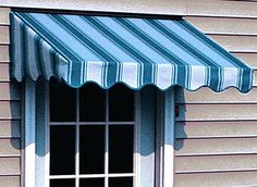 a blue and white striped awning next to a window