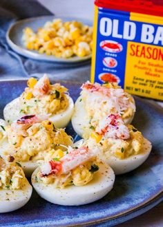 an old bay season egg dish on a blue plate next to a carton of old bay season eggs