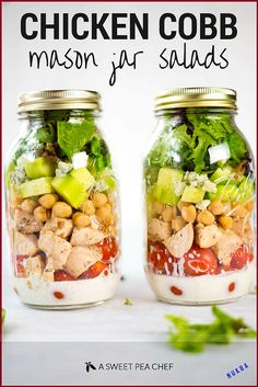 two mason jars filled with chicken cobb salad