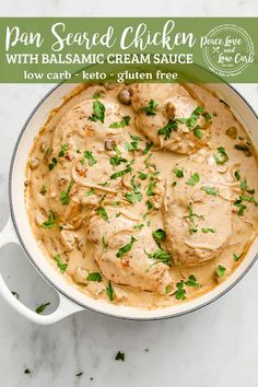 a pan filled with chicken and cream sauce on top of a white marble countertop