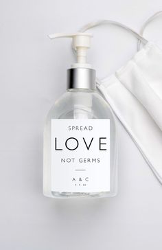 a bottle of love not germs hand sanitizer next to a face mask