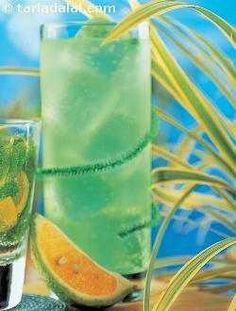 two tall glasses filled with green liquid and orange slices