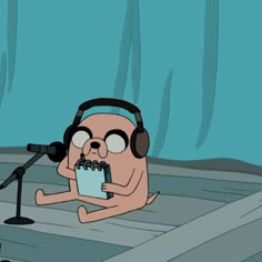 a cartoon character with headphones on sitting in front of a microphone and holding a piece of paper