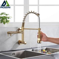 a person is holding the faucet in front of a sink with water running from it