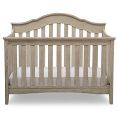 a wooden crib with white sheets on the bottom and side rails, against a white background