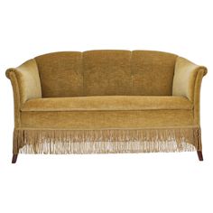 a brown couch with fringes on it